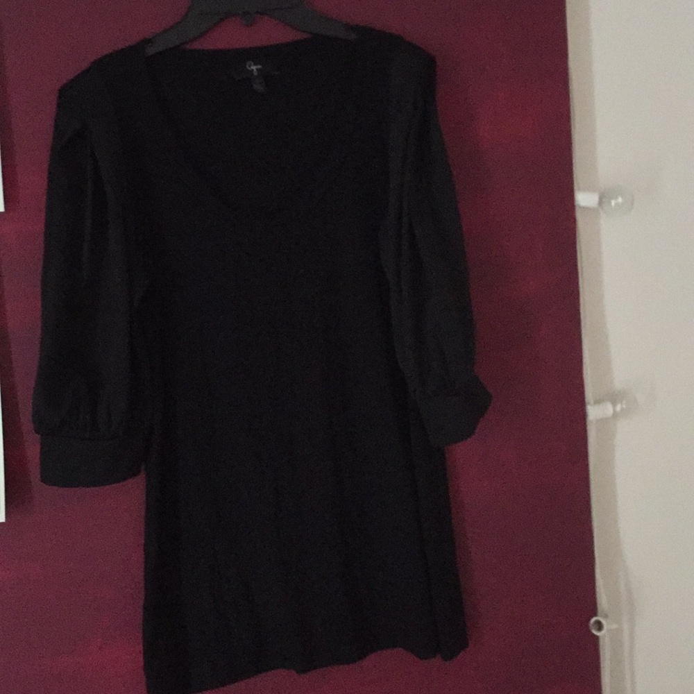 Black scoop neck top with satiny sleeves.
